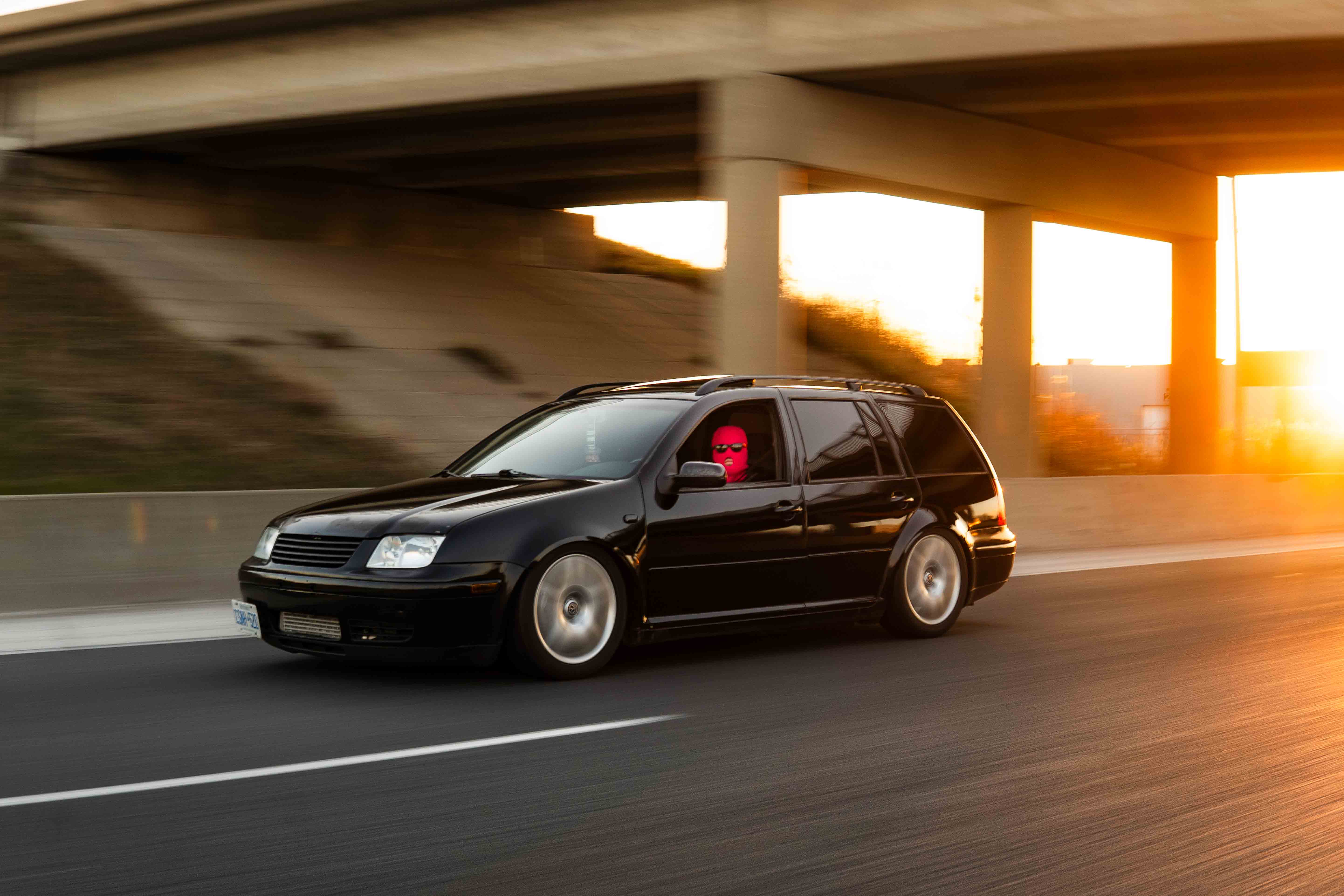 Rolling shot of Nolan’s Mk4 Jetta Wagon at sunset on the highway